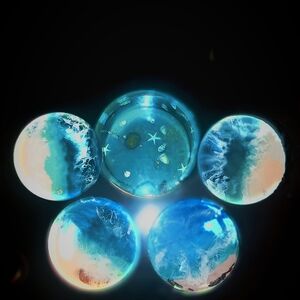 Set of Four Customized Resin Coasters With A Colorful Translucent Ocean Scene.
